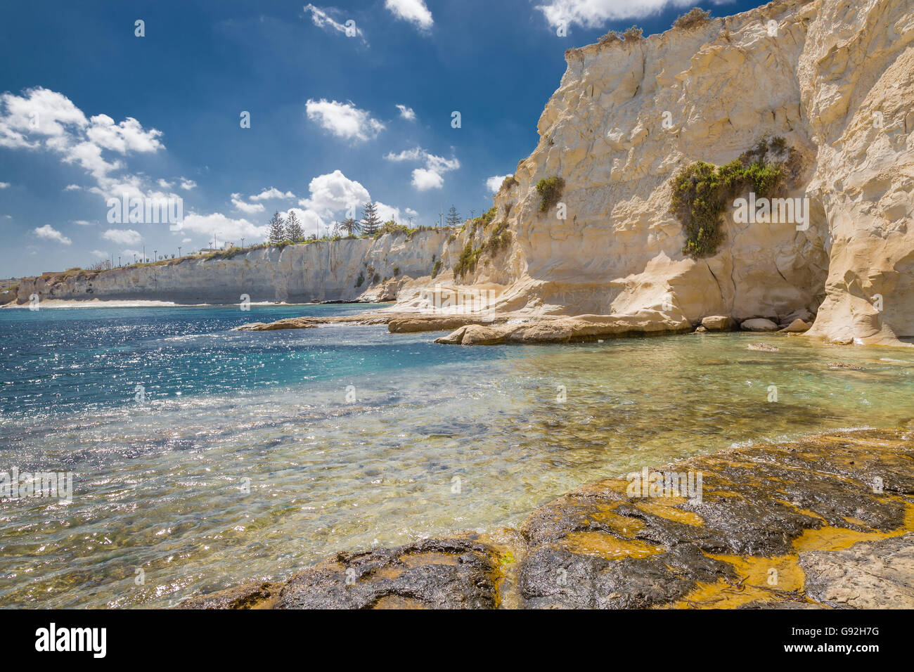 Felsiger Strand in Marsaskala Bucht an der Küste der Insel Malta im Mittelmeer. Stockfoto