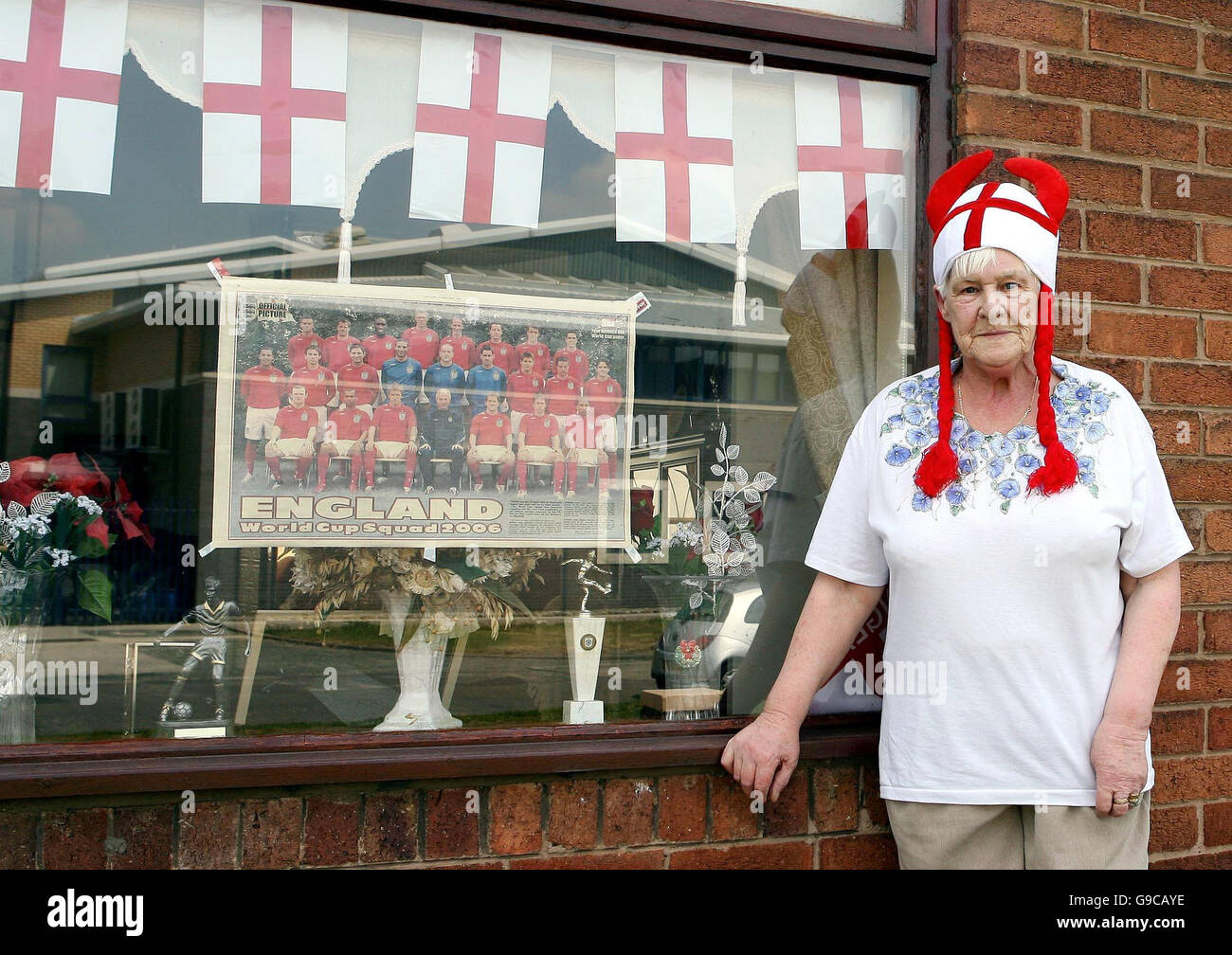 Wayne Rooneys Großmutter Pat Morrey, 74, zeigt ihre Unterstützung für die englische Fußballmannschaft vor dem Eröffnungsspiel gegen Paraguay, indem sie ihr Haus auf der Terrasse in Croxteth, Merseyside, mit 22 St. George's Fahnen schmückt. Stockfoto