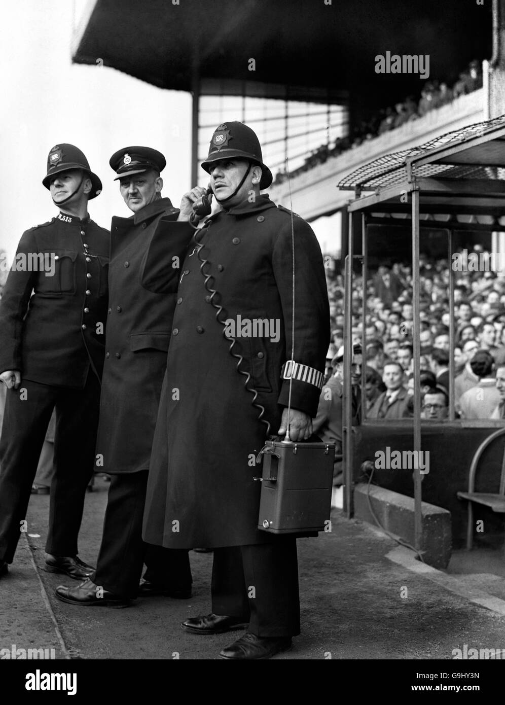 Fußball - FA Cup - Sechste Runde - Arsenal gegen Leeds United - Highbury. Ein Polizist spricht mit einem Kollegen über sein neues Walkie-Talkie-Telefon. Stockfoto