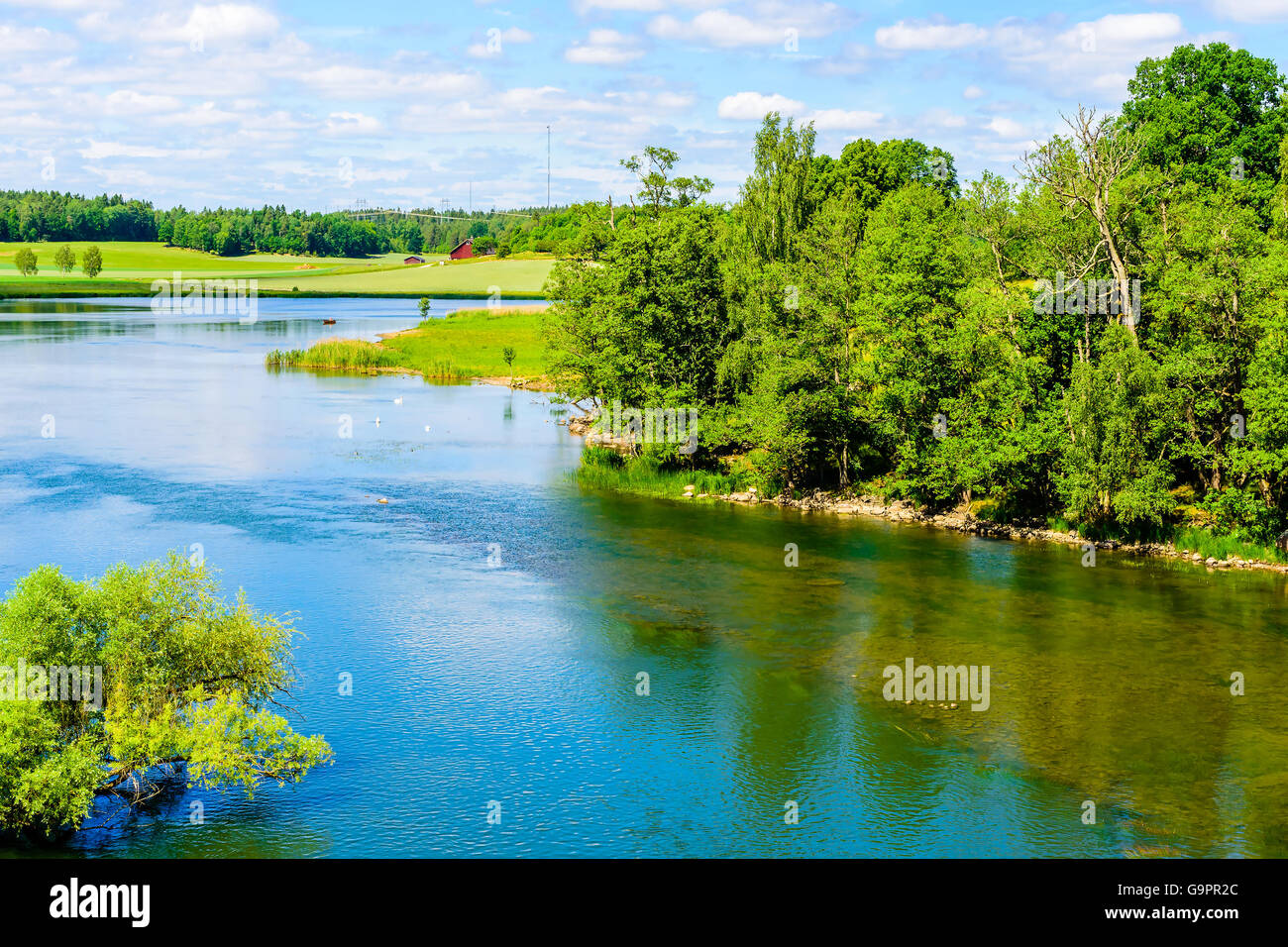 Blick über Norsholm Naturschutzgebiet in Schweden. Es ist der Fluss Motala Strom. In der Ferne ist ein Haus. Sommer in der schwedischen Stockfoto
