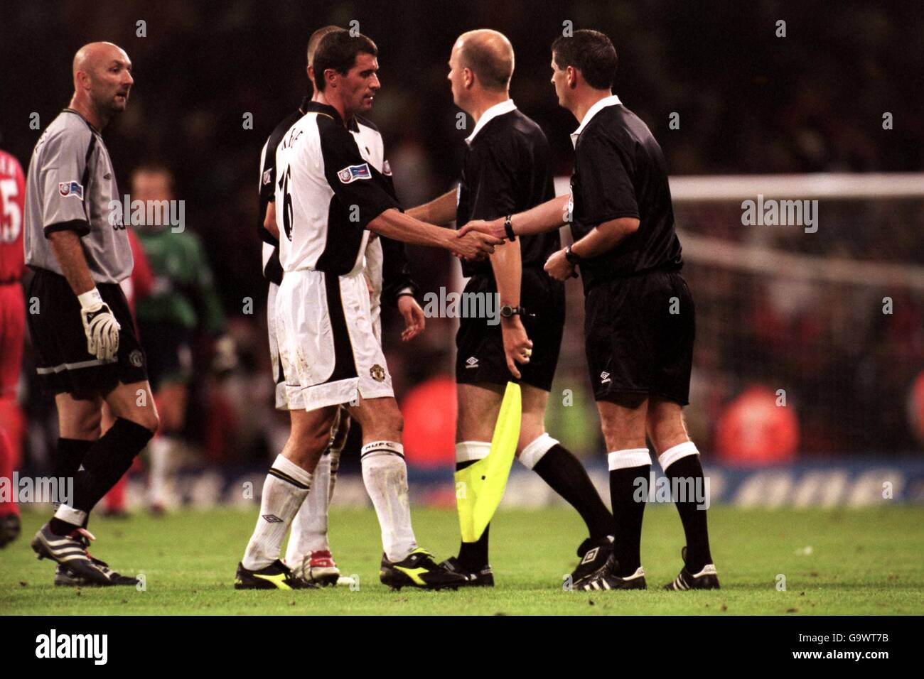 Manchester United Kapitän Roy Keane (c) schüttelt sich die Hände mit dem Schiedsrichter Andy D'Urso (r) als Torwart Fabien Barthez (l) wartet darauf Beschweren Sie sich Stockfoto