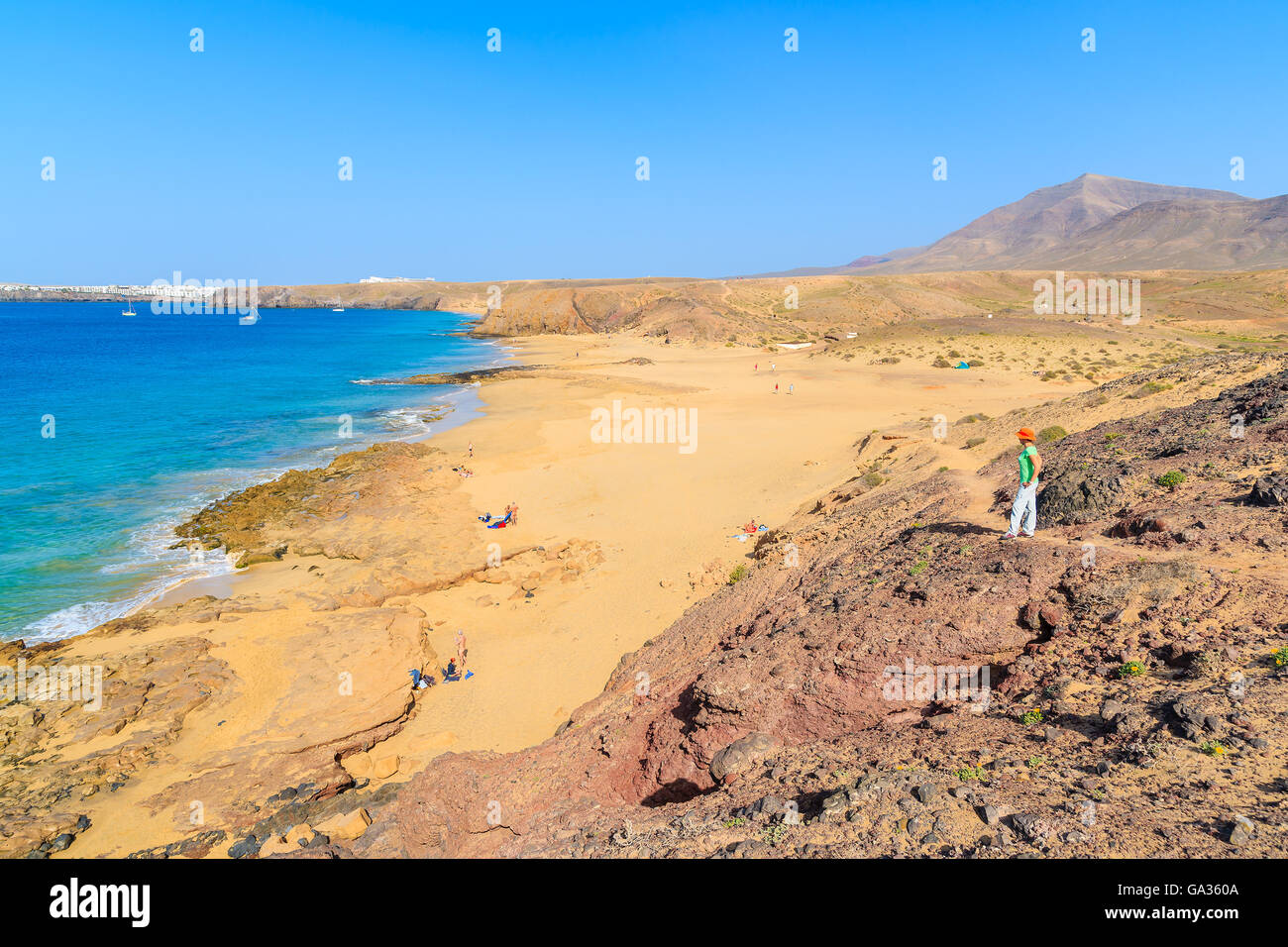 Junge Frau Touristen stehen auf Klippe Blick auf Papagayo Strand, Lanzarote, Kanarische Inseln, Spanien Stockfoto