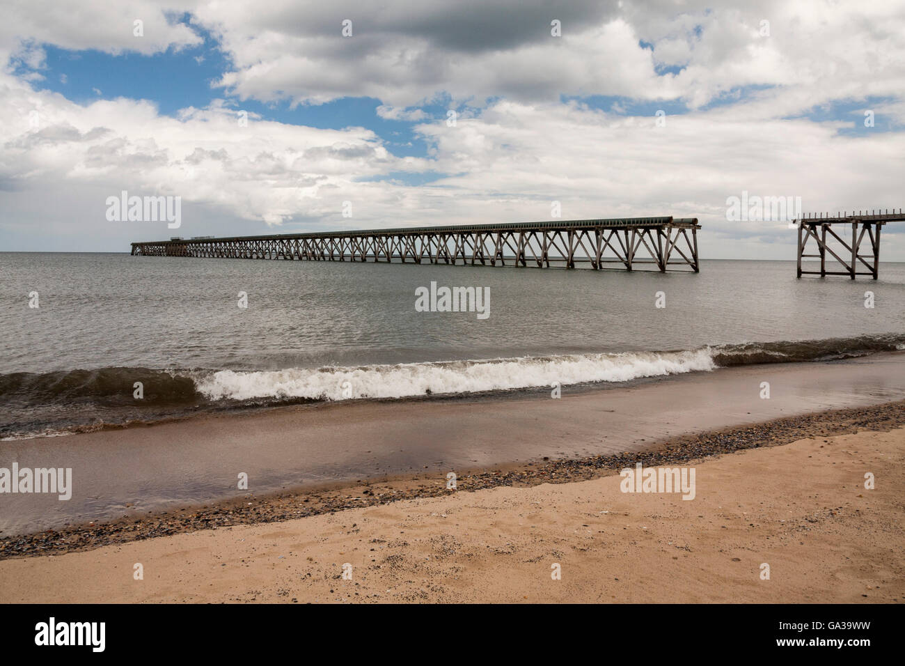 Ein Blick auf Steetley Pier, Hartlepool auf der nordöstlichen Küste von England, UK zeigt Strand, ankommenden Gezeiten und blauen Wolkenhimmel Stockfoto