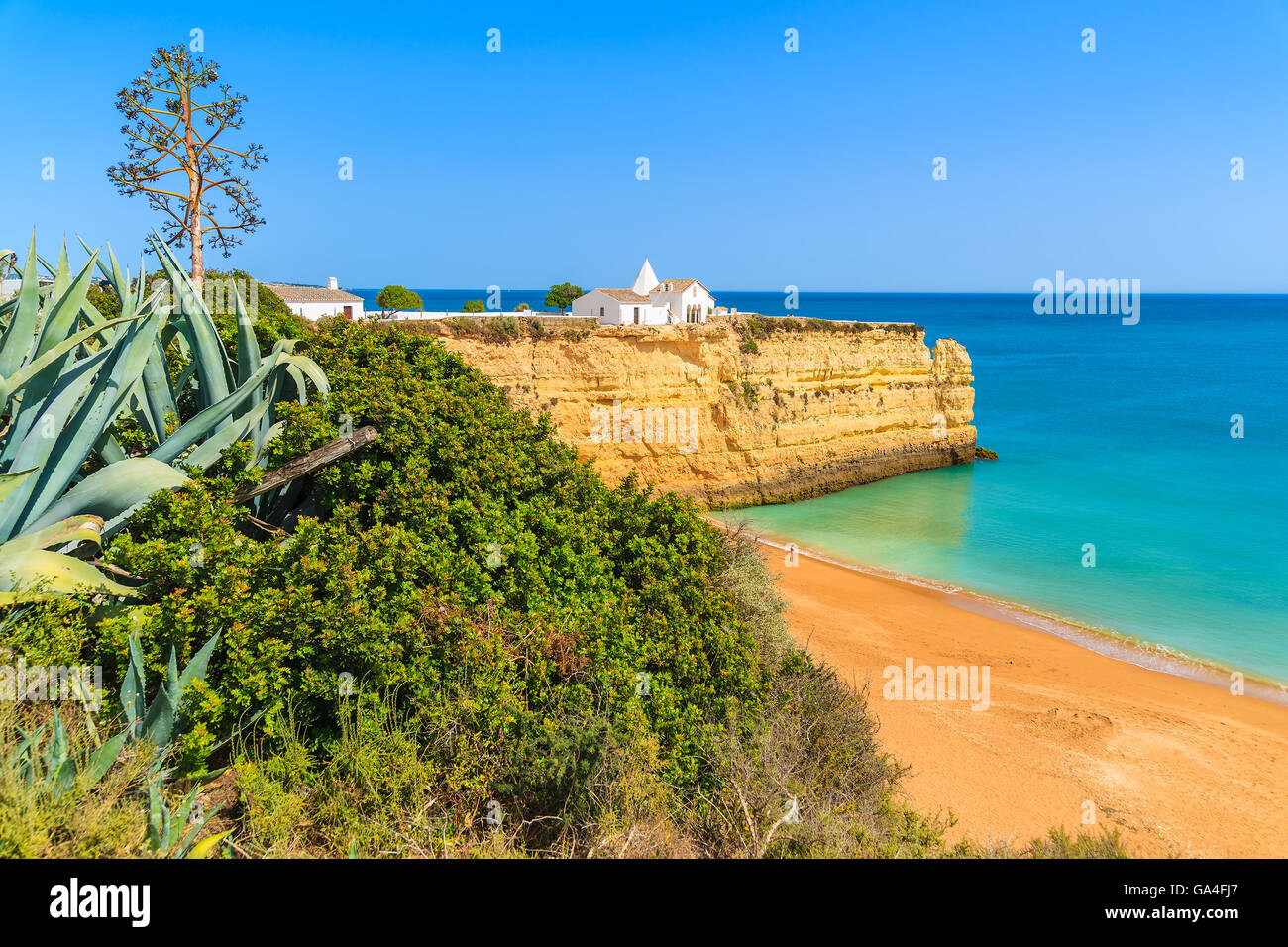 Weiße kleine Kirche auf Felsen am Strand von Armacao de Pera, Region Algarve, Portugal Stockfoto