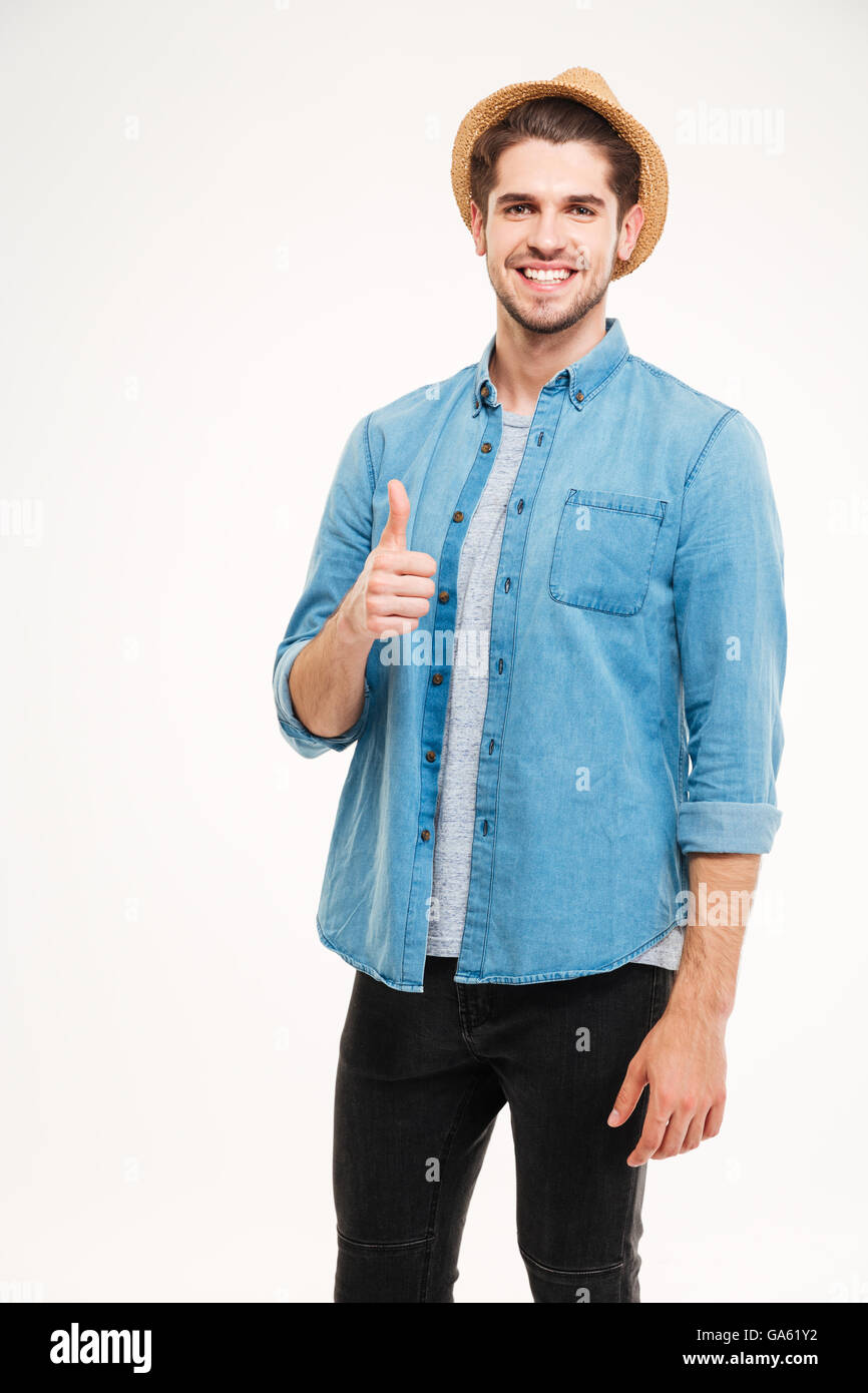 Fröhlichen junger Mann Daumen auftauchend isoliert auf weißem Hintergrund Stockfoto
