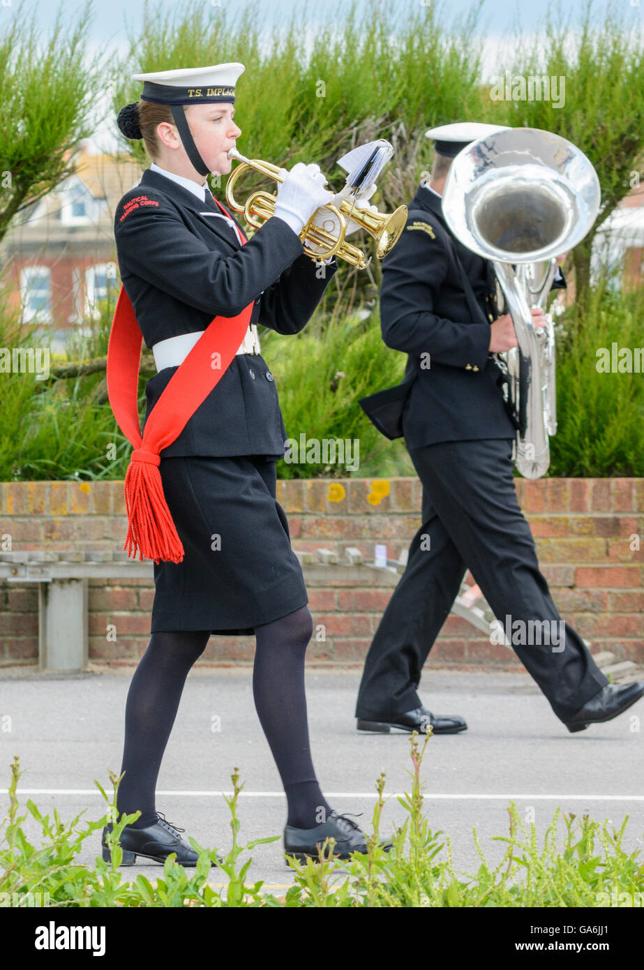 Junge weibliche in militärischen uniform spielen Trompete in einer Militärkapelle beim marschieren. Stockfoto