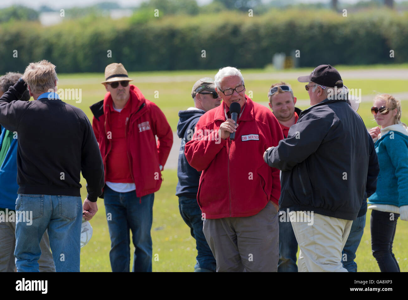 Dave Bishop von DB Sound in rote Jacke mit Piloten am Flügel ' n ' Wheels North Weald Airfield Epping Essex England Stockfoto