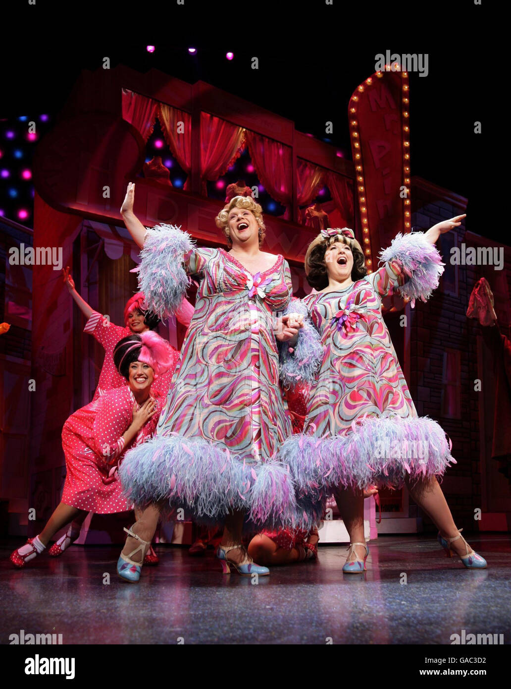 Die Besetzung des Musicals 'Hairspray', darunter Leanne Jones (vorne rechts als Tracy Turnblad) und Michael Ball (vorne links, Edna Turnblad) während eines Fotoalles im Shaftesbury Theatre im Zentrum von London. Stockfoto