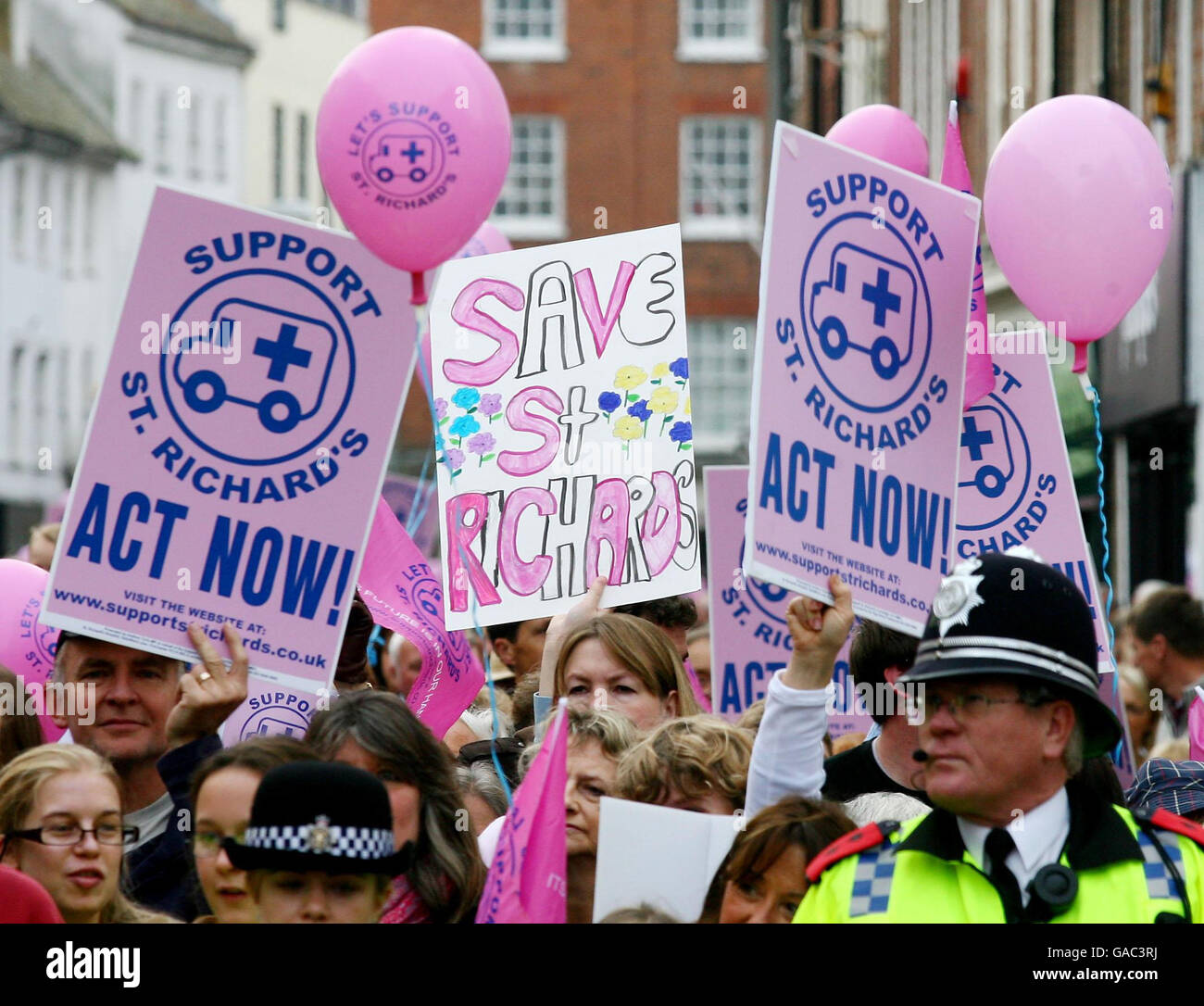 Demonstranten halten Plakate während einer Kundgebung im Priory Park Chichester, Sussex, gegen vorgeschlagene Kürzungen der Dienste im St. Richard's Hospital. Stockfoto
