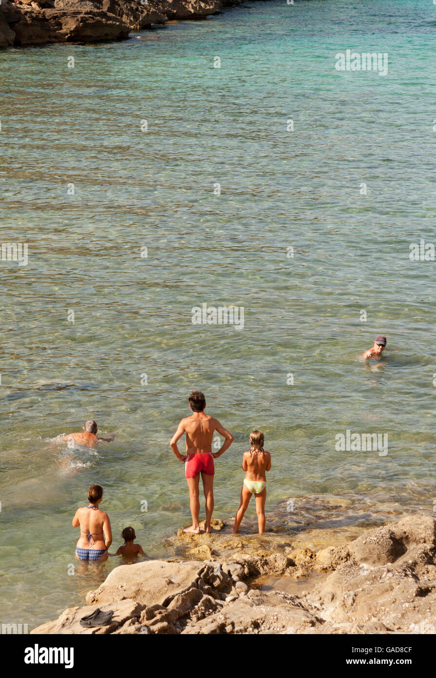 Eine Familie im Urlaub schwimmen im Mittelmeer, Cala Sant Vincenc Strand Mallorca Spanien Europa Stockfoto