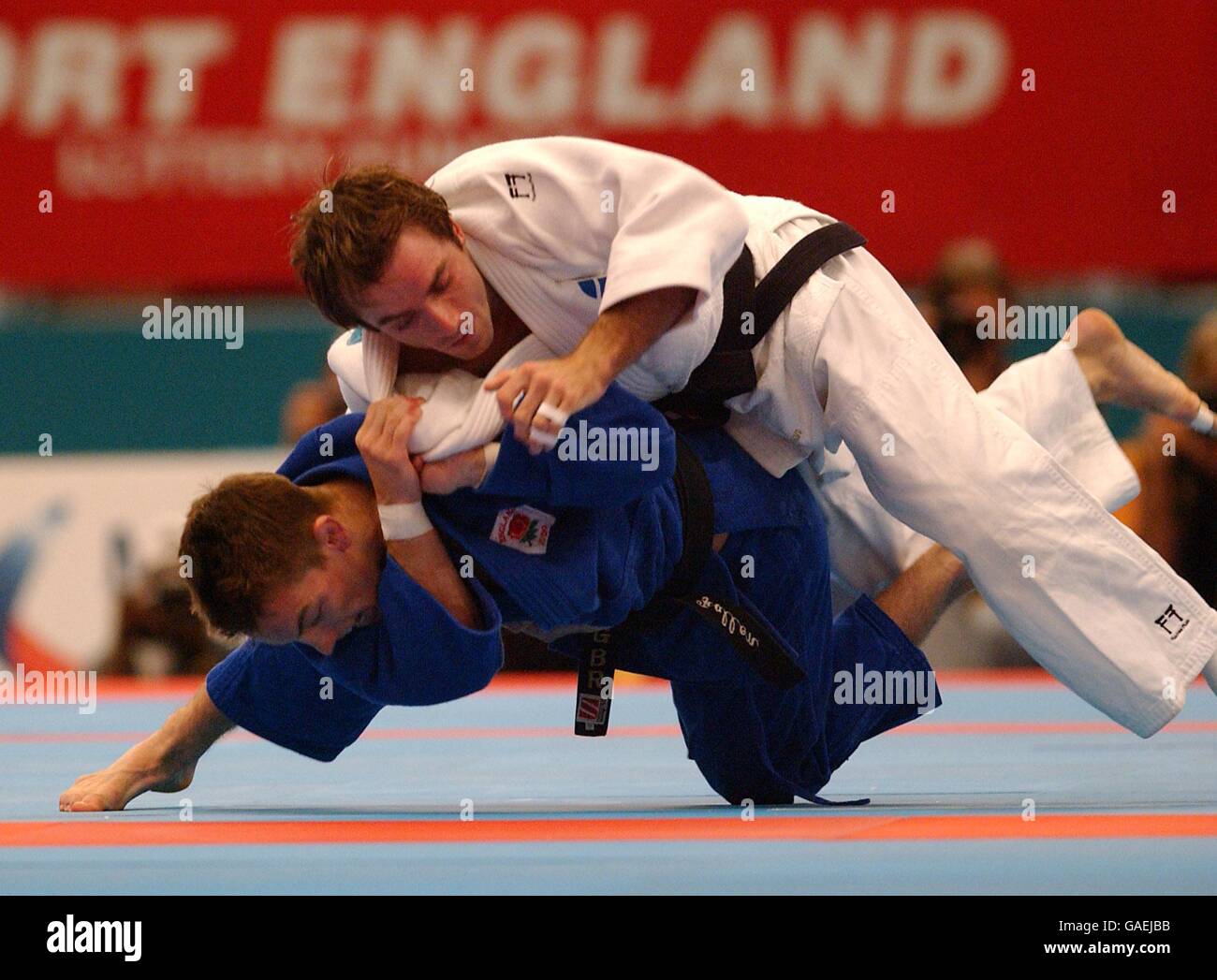 Englands Craig Fallon (blau) wirft den schottischen John Buchanan (weiß) Stockfoto