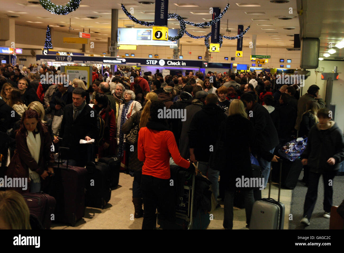 Nebel verzögert den Weihnachtsurlaub. Passagiere stehen im Terminal 1 des Flughafens Heathrow an, nachdem starker Nebel zahlreiche Flugausfälle verursacht hatte. Stockfoto