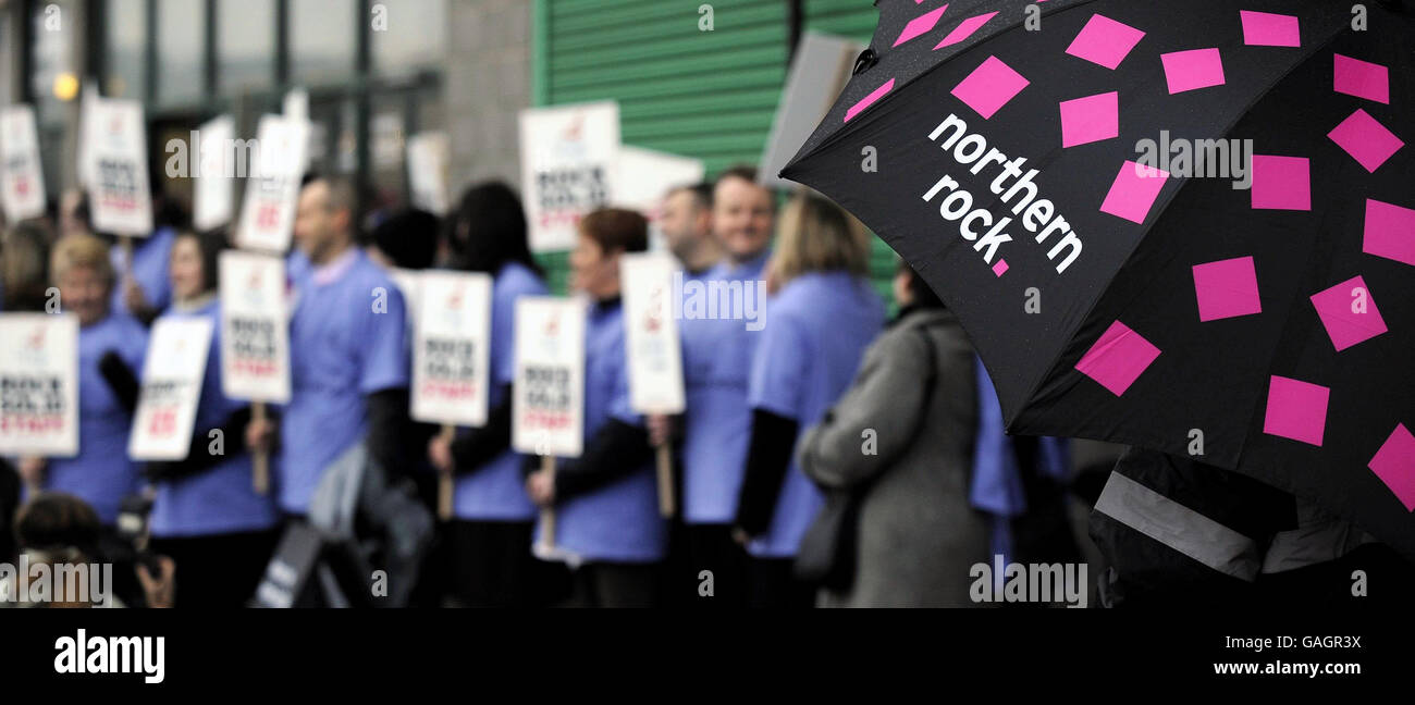 Mitarbeiter der Northern Rock Bank halten Plakate, während die Delegierten in der Newcastle Metro Arena zu einem Treffen über den geplanten Verkauf der Bank ankommen. Stockfoto