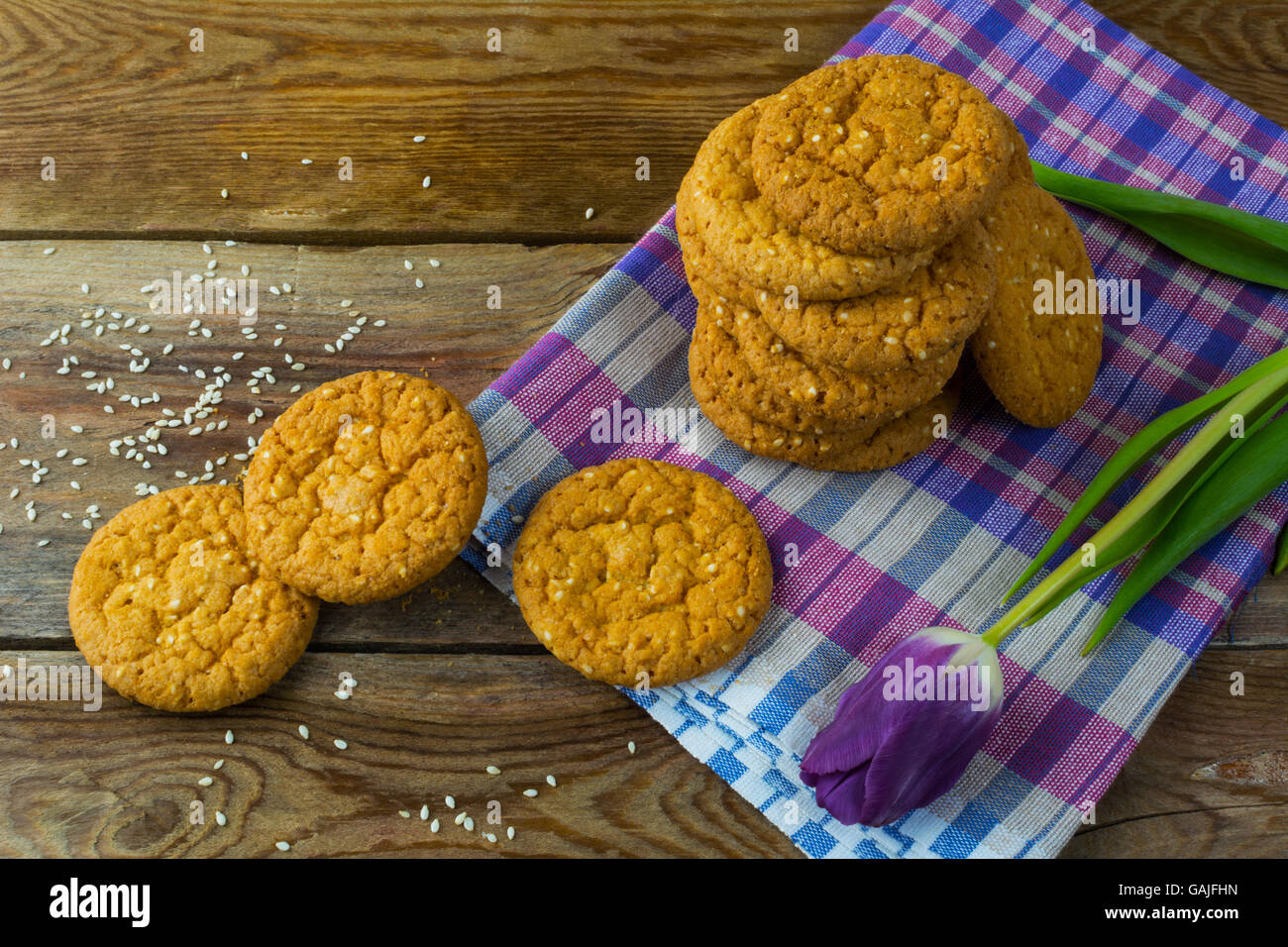 Sesam-Kekse und lila Tulpe die Leinen Serviette. Frühstück-Cookie. Dessert-Cookies. Cookies. Cookie. Dessert. Frühstück. Süß Stockfoto