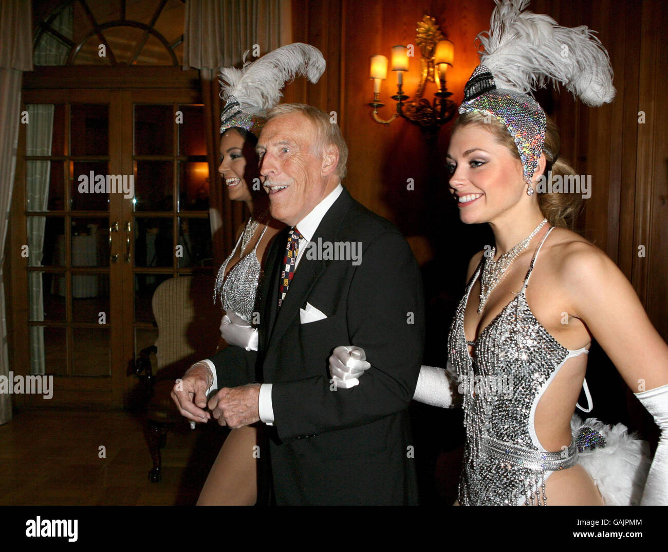 Bruce Forsyth wird von Miss Puerto Rico (links) und Miss England begleitet, um seinen 80. Geburtstag im Dorchester Hotel im Zentrum von London zu feiern. Stockfoto