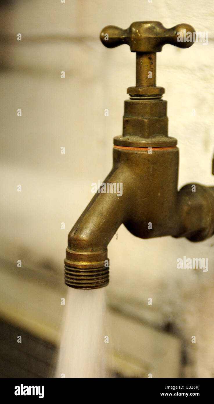 Wasserrechnungen steigen. Eine allgemeine Ansicht des Wassers, das aus einem Wasserhahn tropft. Stockfoto