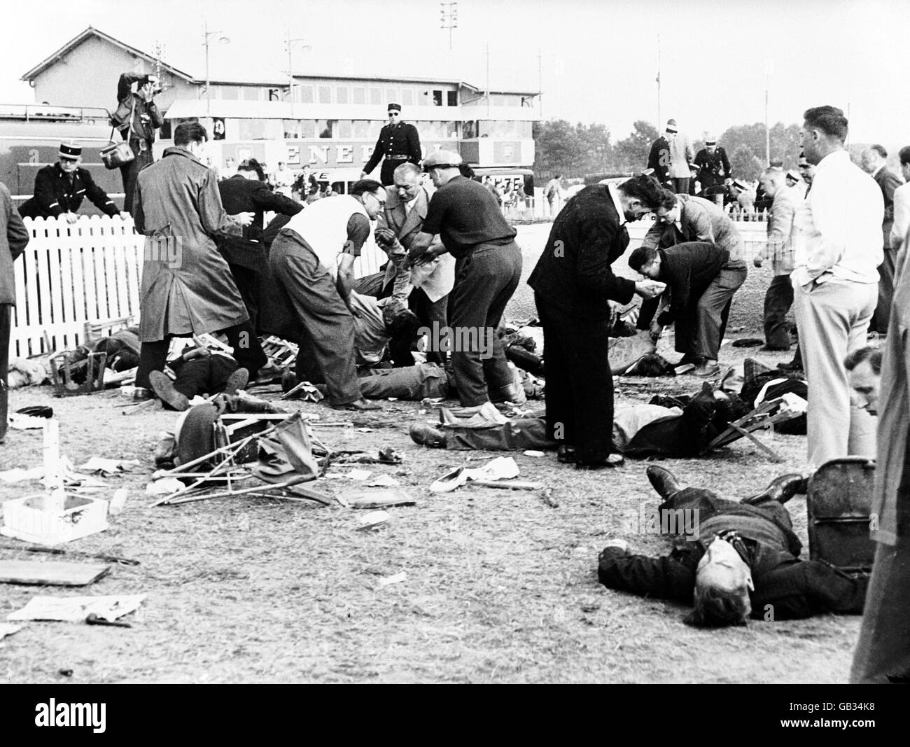 Freiwillige versuchen, verletzten Zuschauern nach dem schlimmsten Unfall in der Motorsportgeschichte zu helfen, als Pierre Leveghs Mercedes auf der Zielgeraden explodierte und riesige Teile seines Autos in die Menge flog, was zu 83 Todesfällen führte Stockfoto