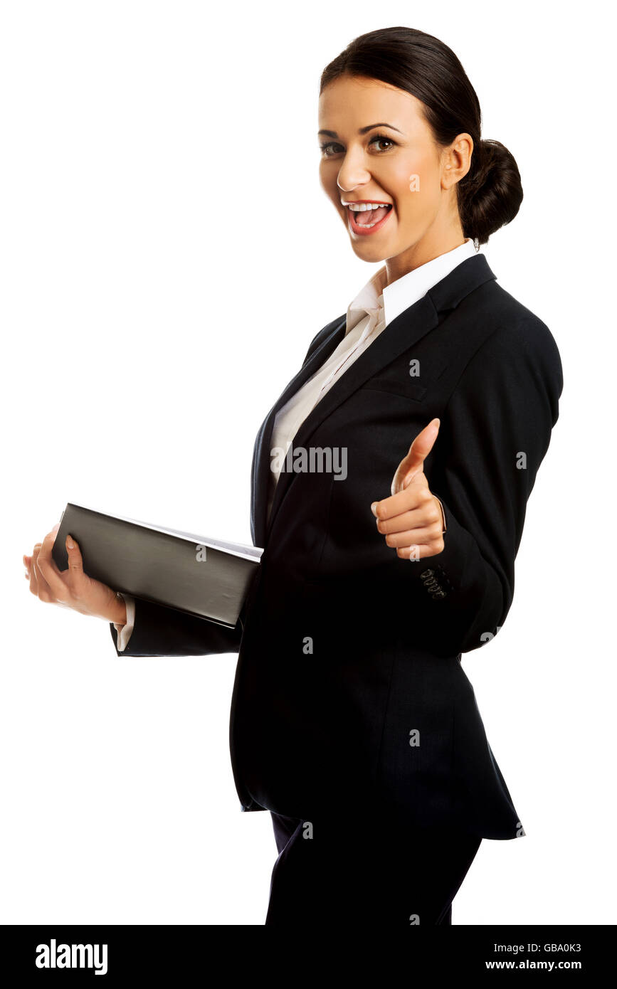 Geschäftsfrau hält Notizen und Daumen auftauchen Stockfoto