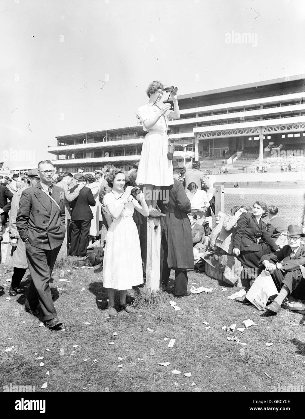 Pferderennen, Epsom Derby, 1950. Eine junge Dame steht auf einem Posten, um das Derby in Epsom zu sehen. Stockfoto