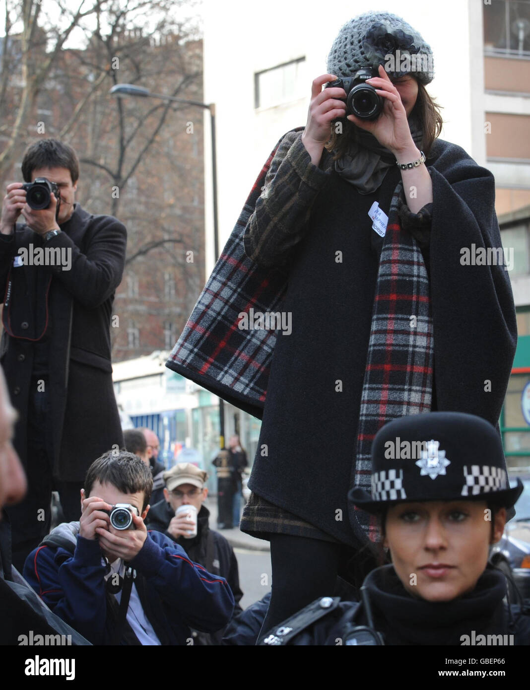 Fotografen fotografieren heute Polizeibeamte vor dem New Scotland Yard in London, als etwa 150 Fotografen aus Protest gegen ein neues Anti-Terror-Gesetz ein Massenfoto schießen. Fotojournalisten sagen, dass Sektion 76 des Anti-Terror-Gesetzes, das heute Gesetz wurde, sie wegen ihrer Arbeit verhaftet sehen könnte. Stockfoto