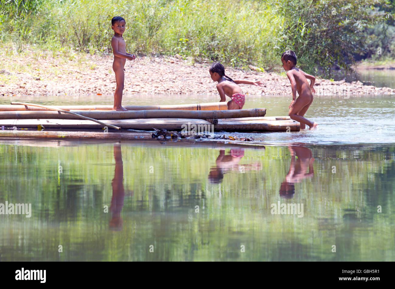 Khao Sok, Nationalpark, Thailand - 2. Mai 2016: unbekannte Kinder spielen und waschen im Wasser am Flüsschen. Stockfoto