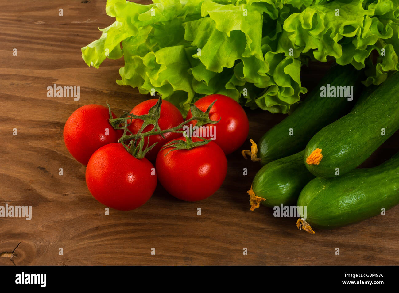 Gurken und Tomaten auf hölzernen Hintergrund. Tomaten.  Gurke.  Reife Gemüse. Frisches Gemüse. Cherry-Tomate. Stockfoto