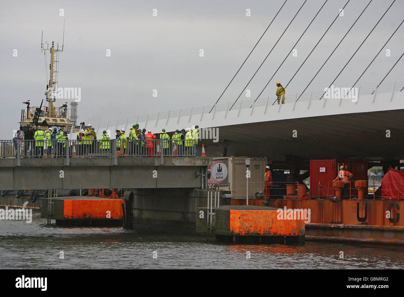 Ingenieure beobachten heute, wie die Samuel Beckett Bridge auf dem Weg zu ihrem neuen Standort am Liffey in Dublin durch die Mautbrücke der Ostverbindung verläuft. Stockfoto