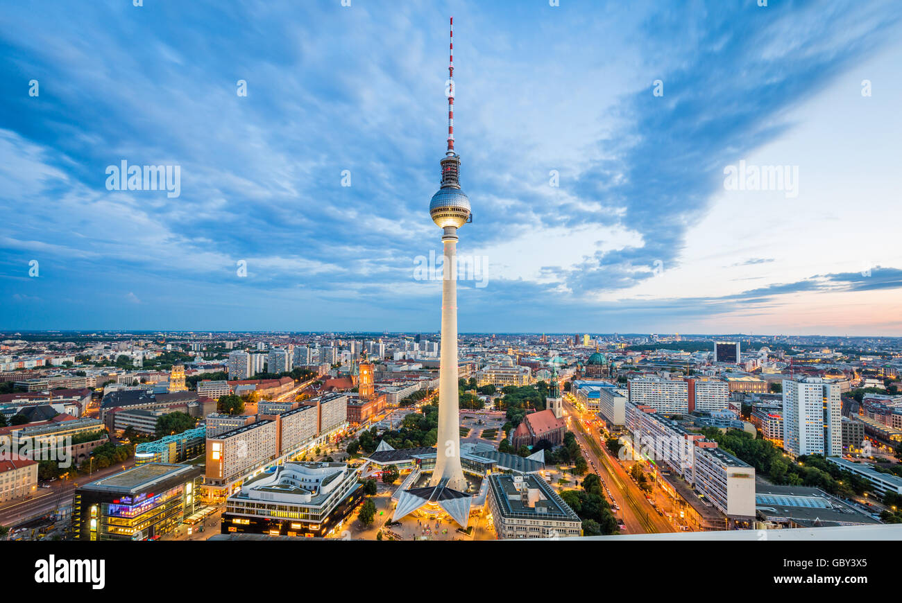 Klassische Luftaufnahme der Berliner Skyline mit berühmten Fernsehturm am Alexanderplatz und dramatische Wolkengebilde im Zwielicht, Deutschland Stockfoto