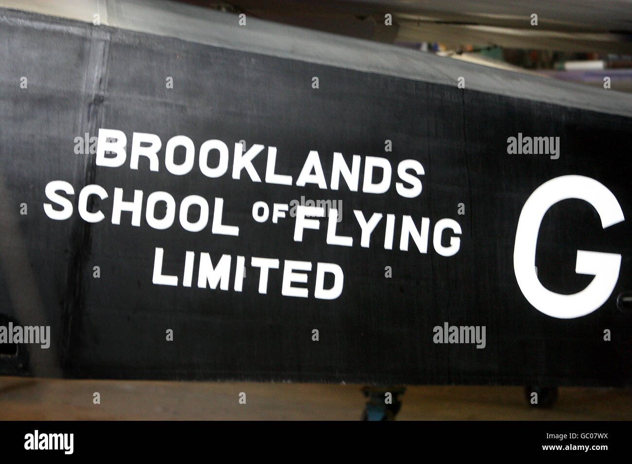 Ein Schild an der Seite eines Flugzeugs, das die Brooklands School of Flying im Brooklands Museum bewirbt. Stockfoto