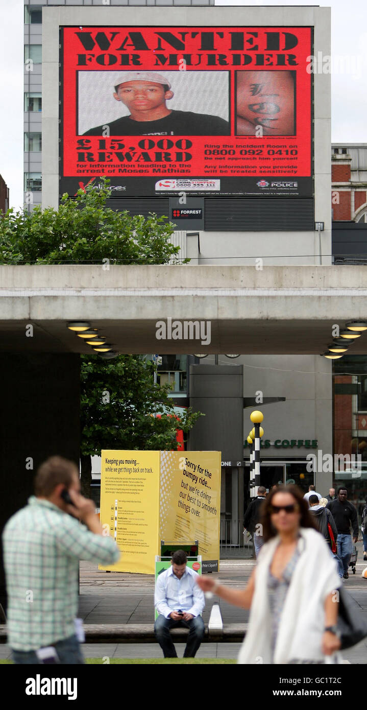 Das gesuchte Plakat, das auf einer elektronischen Plakatwand in Piccadilly Gardens in Manchester gezeigt wird, zeigt Moses Mathias, den 16-jährigen Jungen, der im Zusammenhang mit dem Mord an Giuseppe Gregory gesucht wird, der im Mai erschossen wurde. Stockfoto