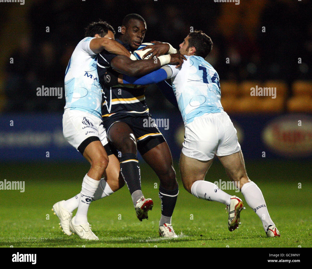 Worcester's Miles Benjamin wird vom Montpellier Frederico Todeschini (links) und Manoel Dall'inga (rechts) während des European Challenge Cup Spiels im Sixways Stadium, Worcester, angegangen. Stockfoto