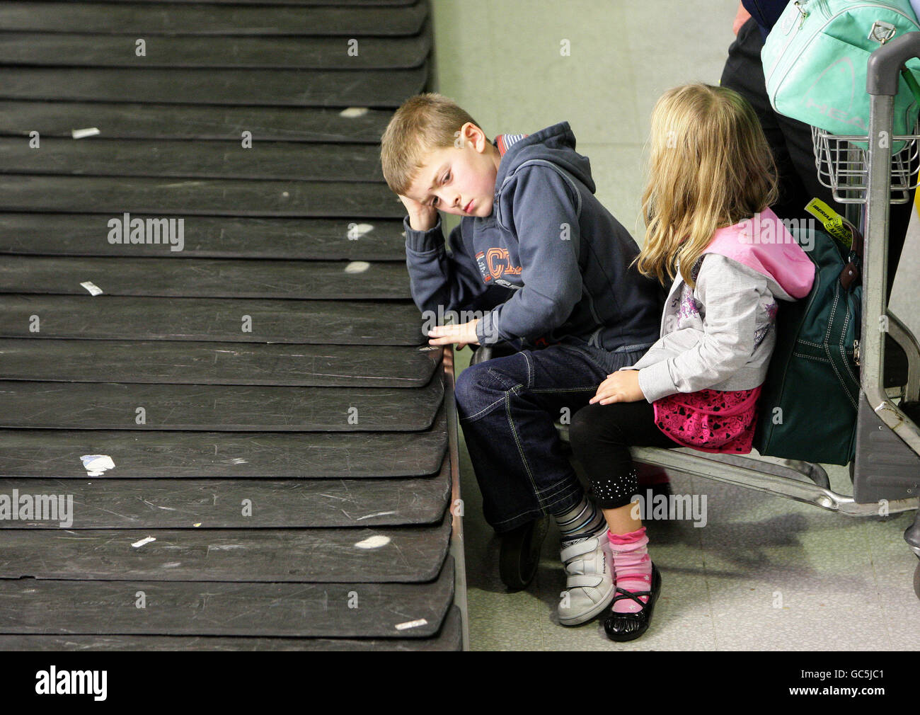 Lager am Flughafen Manchester. Kinder warten auf das Gepäck am Flughafen Manchester, Terminal 2. Stockfoto