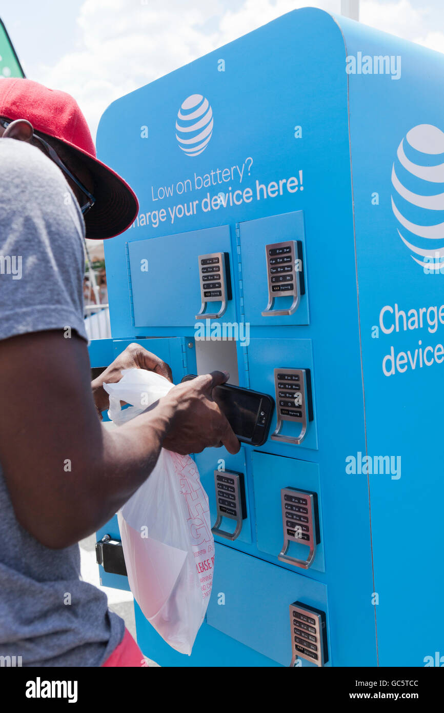 Junger Mann mit einer AT&T mobile Ladestation - USA Stockfoto