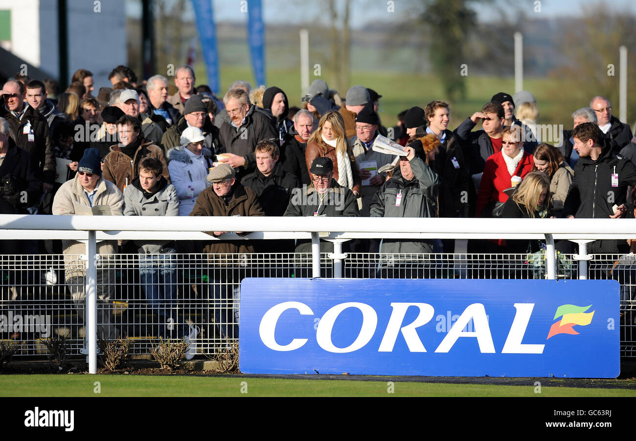 Pferderennen - The Coral Welsh National - Chepstow Racecourse. Racegoers beobachten die Pferde, die im Paradering in Chepstow paradiert sind Stockfoto