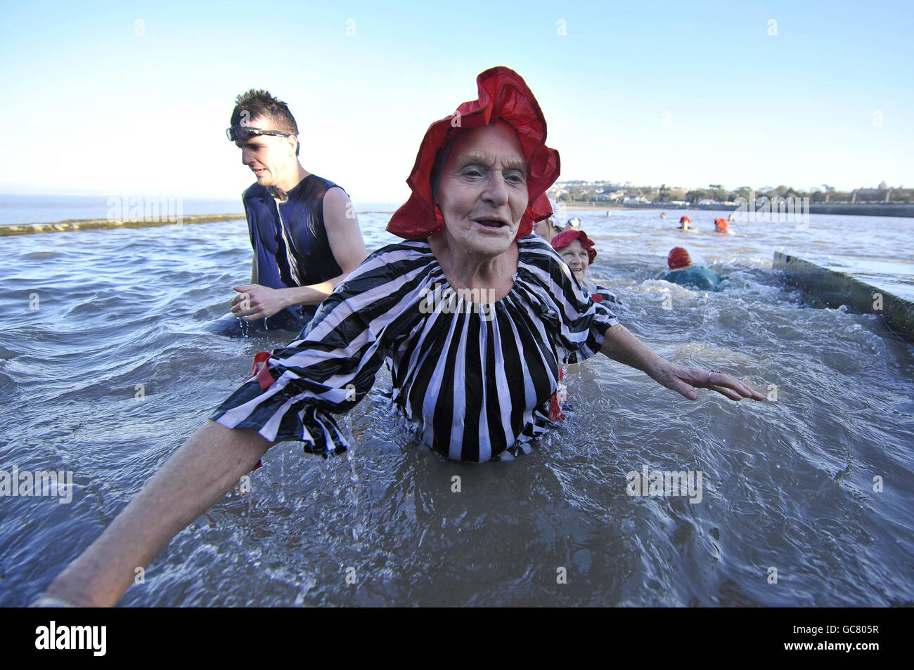 Joyce Peters, 78, aus Clevedon, kommt mit anderen Schwimmern in viktorianischen Badekostümen zusammen, während sie am Neujahrstag in der Marina von Clevedon schwimmen, wo die Temperatur nur knapp über dem Gefrierpunkt liegt. Stockfoto