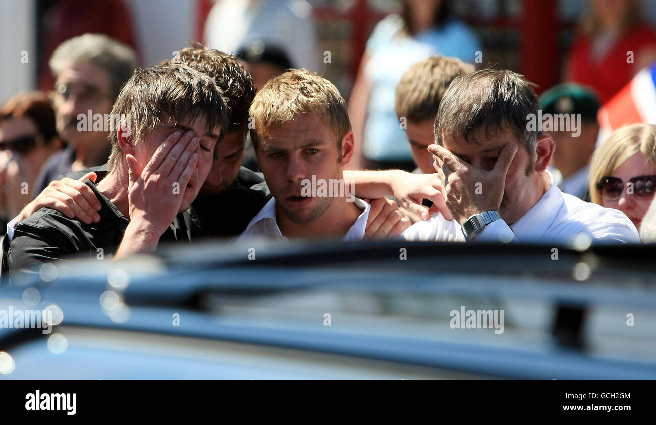 Freunde und Familie von Marine Scott Taylor, von 40 Commando, Royal Marines, trösten sich gegenseitig, während sein Sarg durch Wootton Bassett, Wiltshire, gefahren wird. Stockfoto