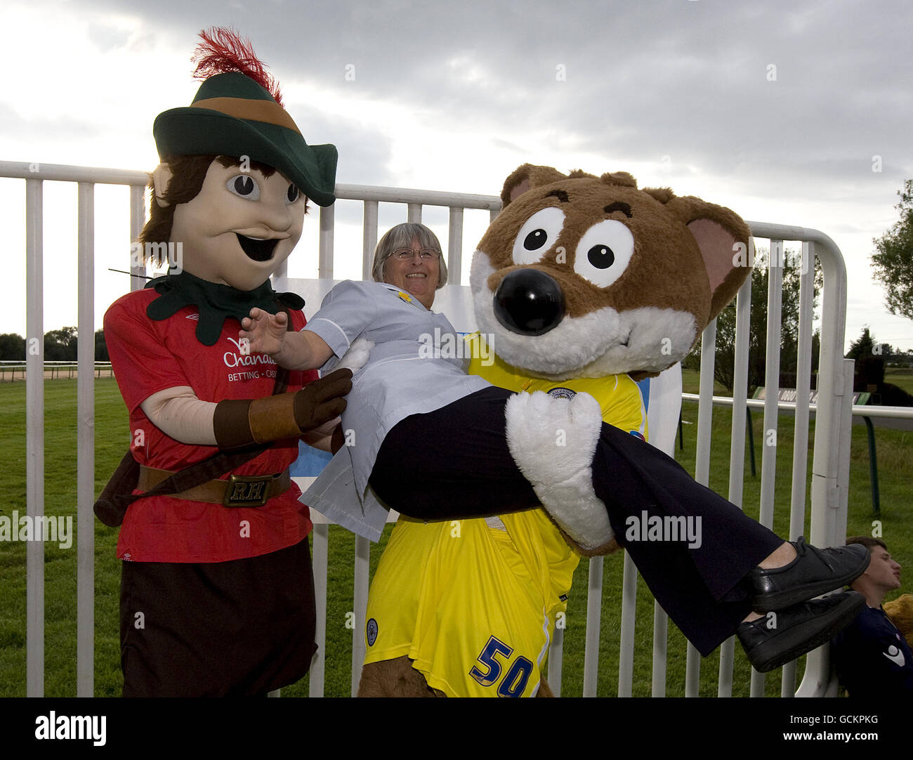 Robin Hood vom Notingham Forest (links) und Filbert Fox von Leicester City Marie Curie Cancer Care registrierte Krankenschwester Ann Atkill für halten Ein Foto Stockfoto