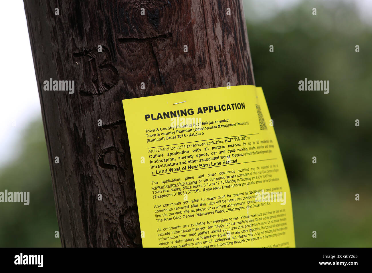 Gelbe Planung Anwendung Plakat klebte an einen Telegrafenmast in Pagham, West Sussex, UK. Pagham ist bedroht von den neuen Häusern. Stockfoto