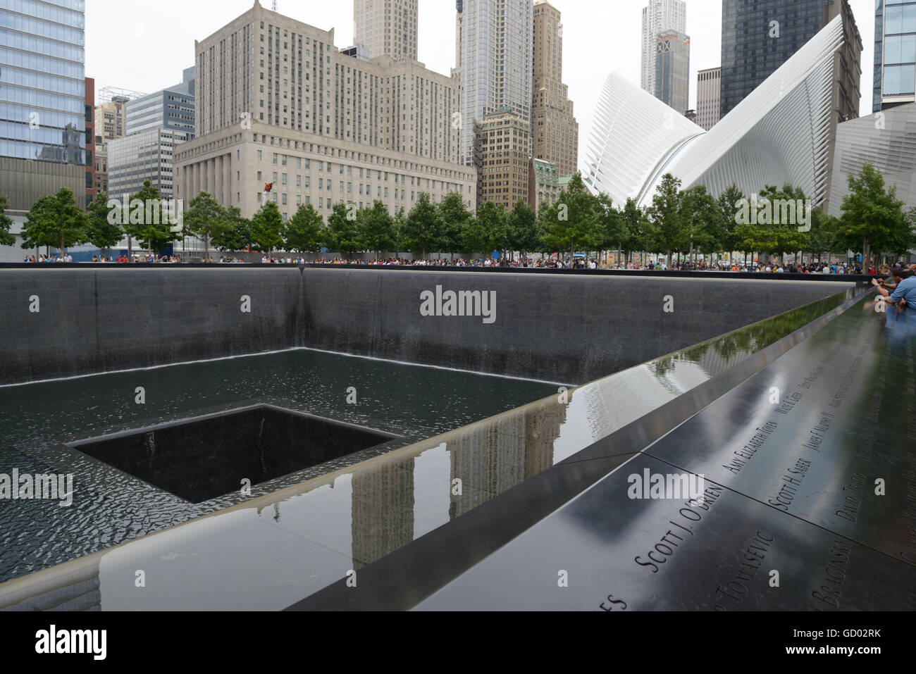 World Trade Center 9/11 Memorial. Website von einem der Türme, die hinunterging, lower Manhattan. Oculus-Transit-Drehscheibe im Hintergrund Stockfoto