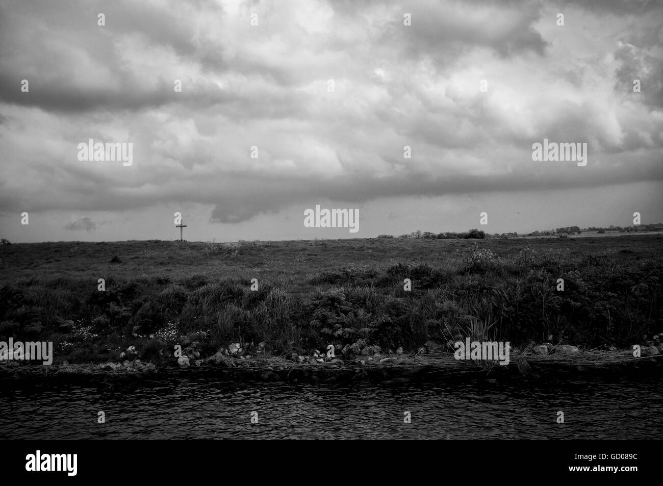 Ein einsamer Kreuz am Ufer der Norfolk Broads gegen einen stürmischen Himmel Stockfoto