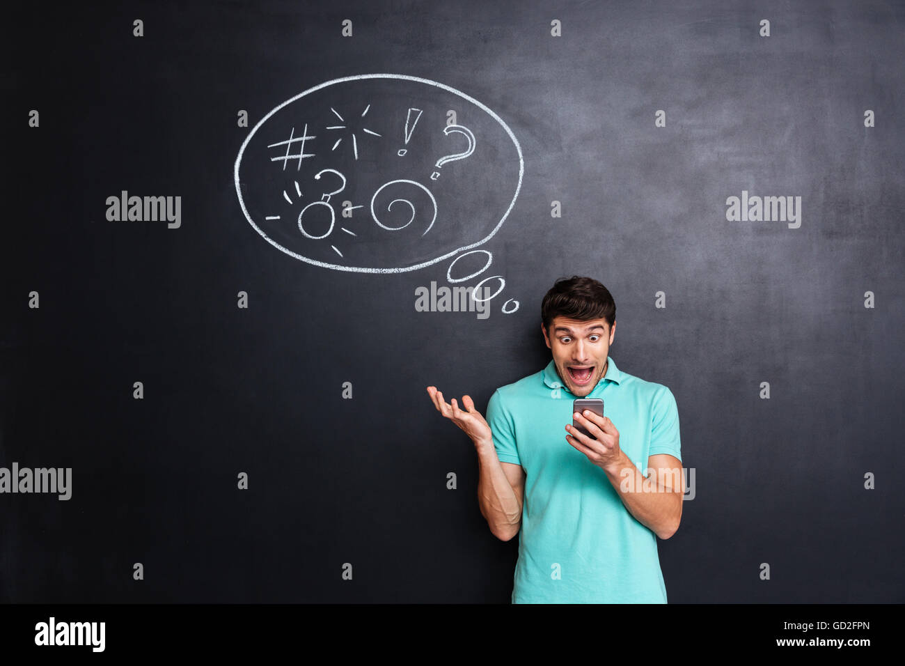 Verrückte hysterisch Jüngling mit Smartphone und schreiend über Tafel Hintergrund mit Sprechblase Stockfoto