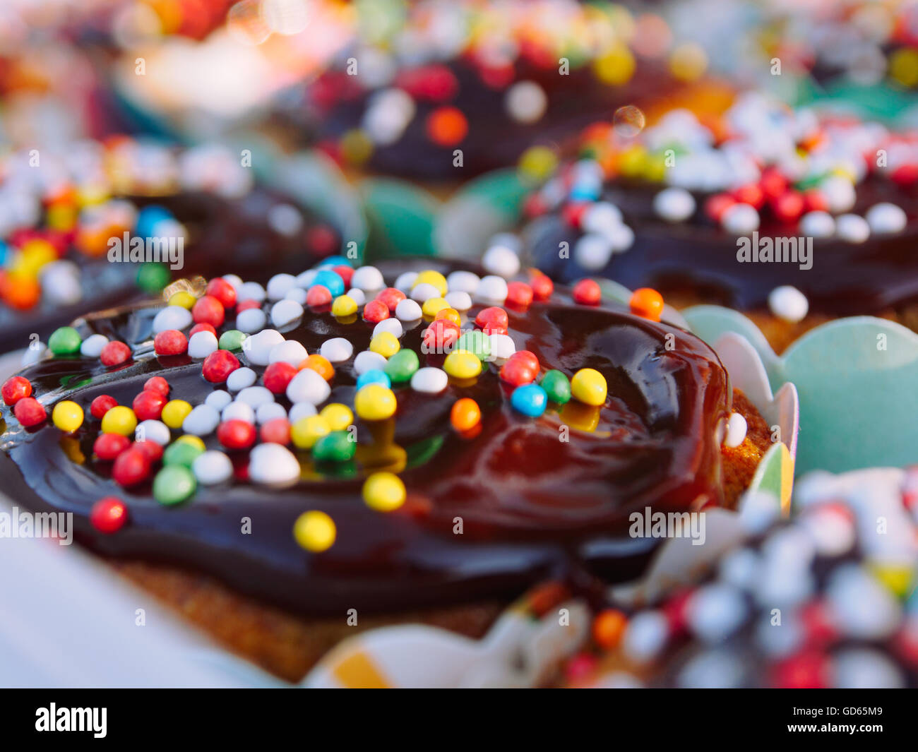 Muffins mit Schokolade und Bonbons bestreuen (Hunderte und Tausende) verziert Stockfoto