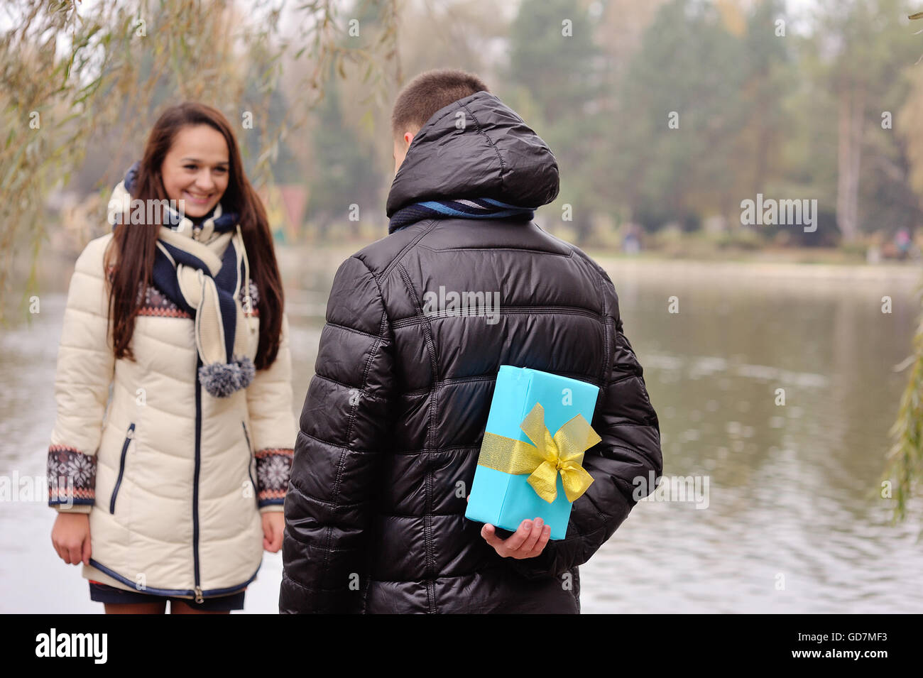 Mann gibt einer Frau einen Geschenk im freien Stockfoto
