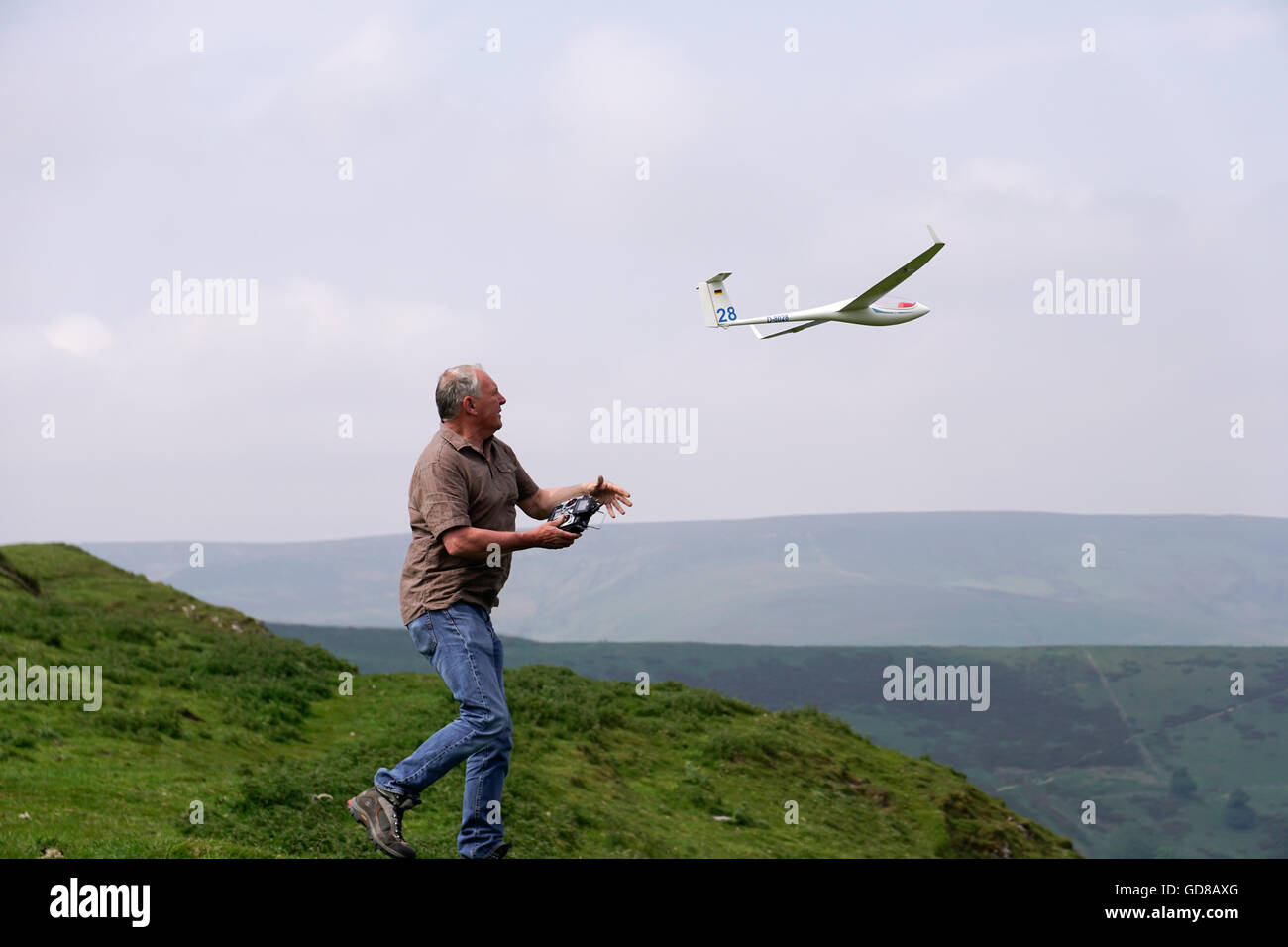 Mann wirft Modell Segelflugzeug aus Hang im Peak District Derbyshire England Stockfoto