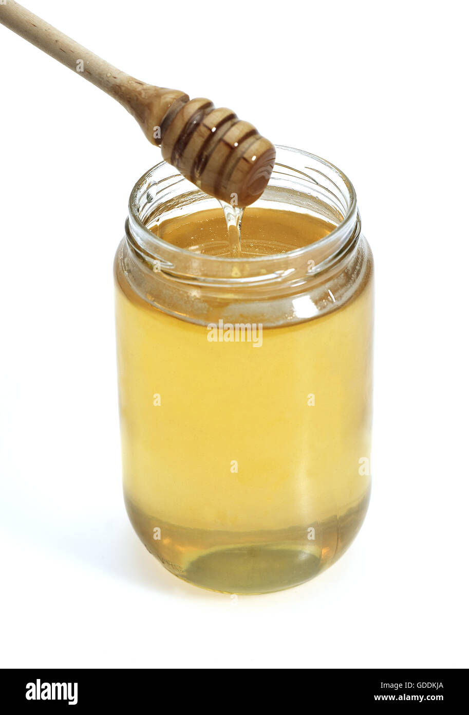Glas Honig mit Honig Löffel vor weißem Hintergrund Stockfoto
