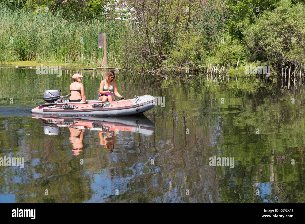 Zwei schöne junge Frauen Bootfahren am White River in der Nähe von Whitehall, Michigan. Stockfoto