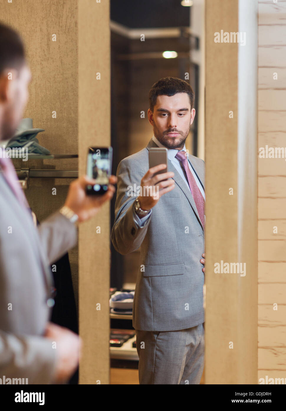 Mann im Anzug unter Spiegel Selfie auf Bekleidungsgeschäft Stockfotografie  - Alamy