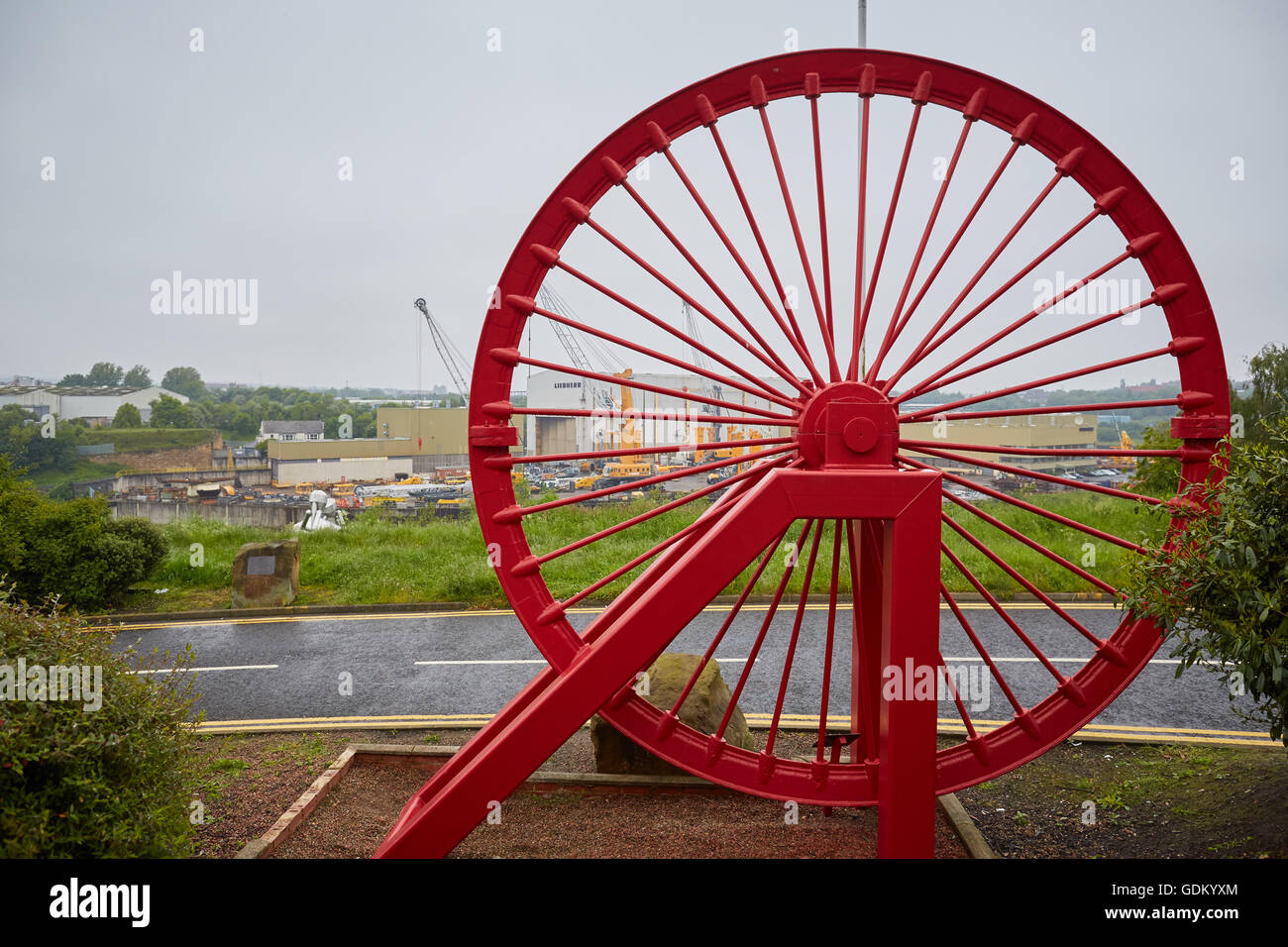 Eine symbolische rote Grube Kopf Rad steht auf dem Gelände der ehemaligen Zeche Wearmouth in Sunderland Co Durham öffentlichen Kunstwerk Recycling Stockfoto
