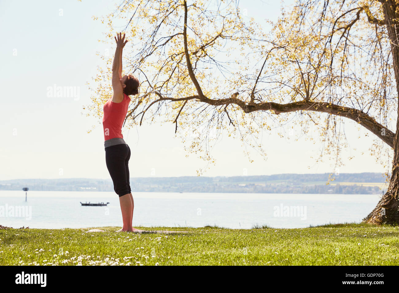 Seitenansicht der Frau, in Yogaposition erhobenen Armen Stockfoto