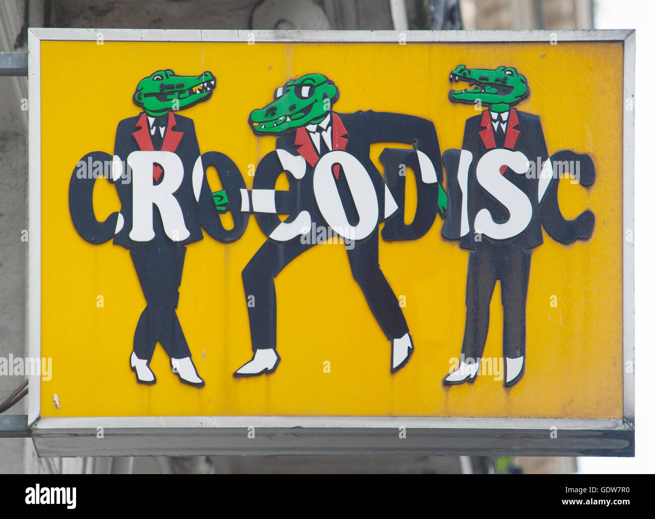 Farbenfrohes SKA Tanzendes Hipster-Krokodil-Schild vor einem Plattenladen in Paris, Frankreich, das die skurrile urbane Straßenkunst-Kultur zeigt. Stockfoto